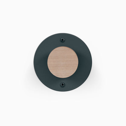 Runda Coat Rack 1 round black wall hook with a natural wood center and two visible mounting screws