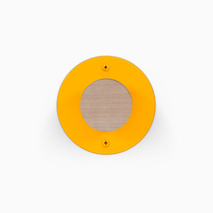 Runda Coat Rack 1 orange circular wall mounted coat rack with a wood center and two visible mounting screws