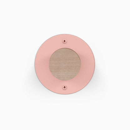 Runda Coat Rack 1 pink circular wall hook with a wood center and two visible mounting screws