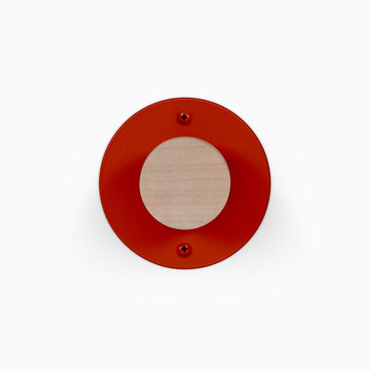 Runda Coat Rack 1 red circular wall mounted coat hook with a natural wood center and two visible mounting screws