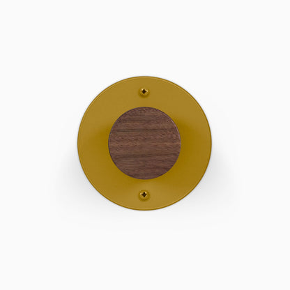 Runda Coat Rack 1 round gold wall hook with a centered wood accent and two visible mounting screws