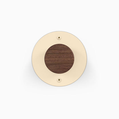 Runda Coat Rack 1 round cream wall mount with a dark wood center and visible mounting screws