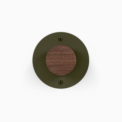 Runda Coat Rack 1 round wall mounted coat hook with an olive green metal plate and walnut wood center