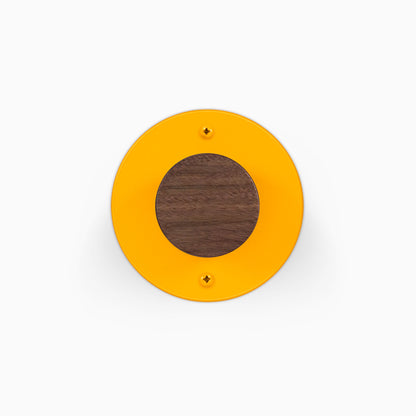 Runda Coat Rack 1 round orange wall hook with a contrasting walnut wood center and two visible mounting screws