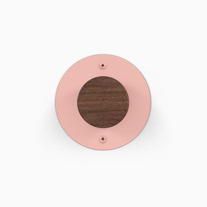 Runda Coat Rack 1 round pink wall hook with a walnut wood center and visible mounting screws