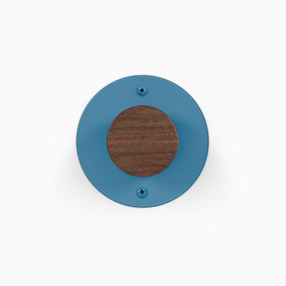 Runda Coat Rack 1 blue circular wall hook with a walnut wood center and two visible mounting screws
