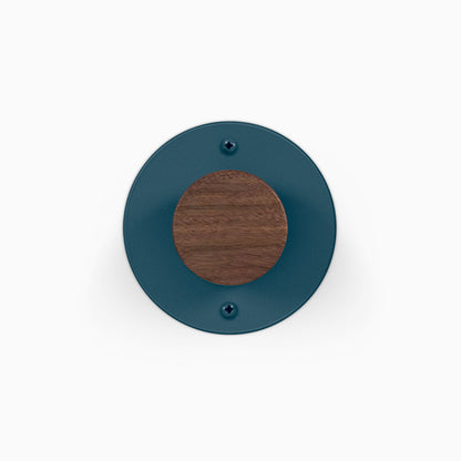 Runda Coat Rack 1 round blue wall mounted coat rack with a wood center and two visible mounting screws