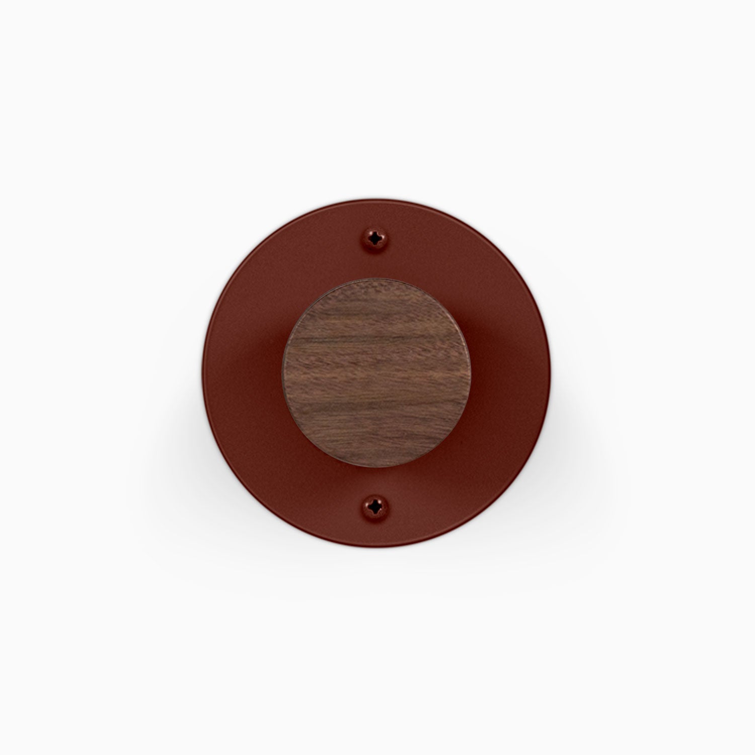 Runda Coat Rack 1 round wall mounted coat hook with a wood peg and visible mounting screws on a rust colored metal plate