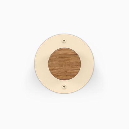 Runda Coat Rack 1 circular wall mounted coat rack with wood center and cream metal plate secured by two screws