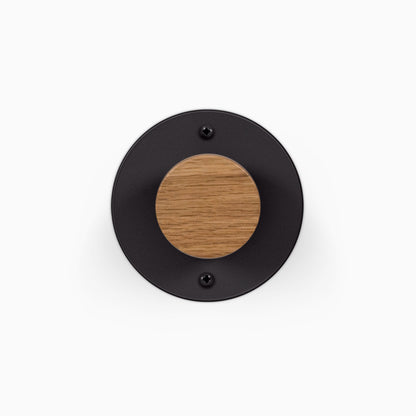 Runda Coat Rack 1 round black wall hook with a solid hardwood center and two visible mounting screws