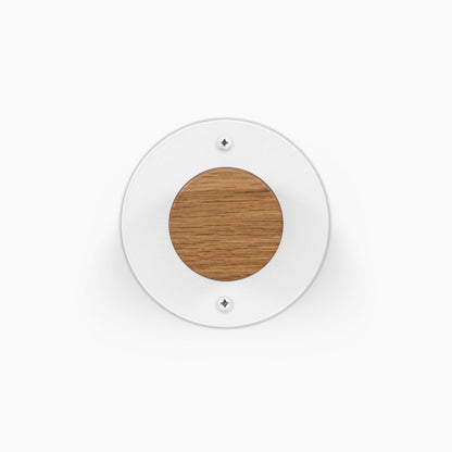 Runda Coat Rack 1 white circular wall mounted coat rack with a round wood accent and visible mounting screws