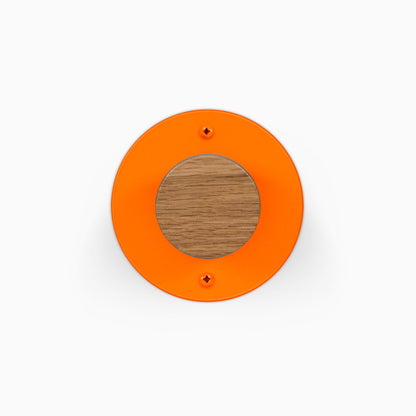 Runda Coat Rack 1 orange circular wall hook with a wood center and two visible mounting screws on a white background