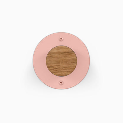 Runda Coat Rack 1 pink round wall hook with a wood center and visible mounting screws