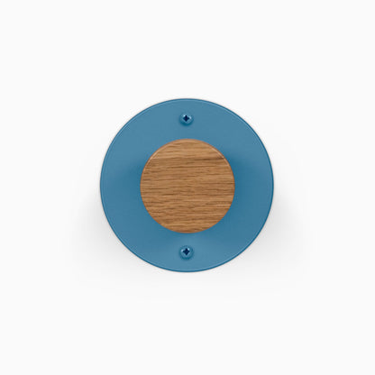 Runda Coat Rack 1 blue circular wall hook with a round wood accent and two visible mounting screws for organized entryways