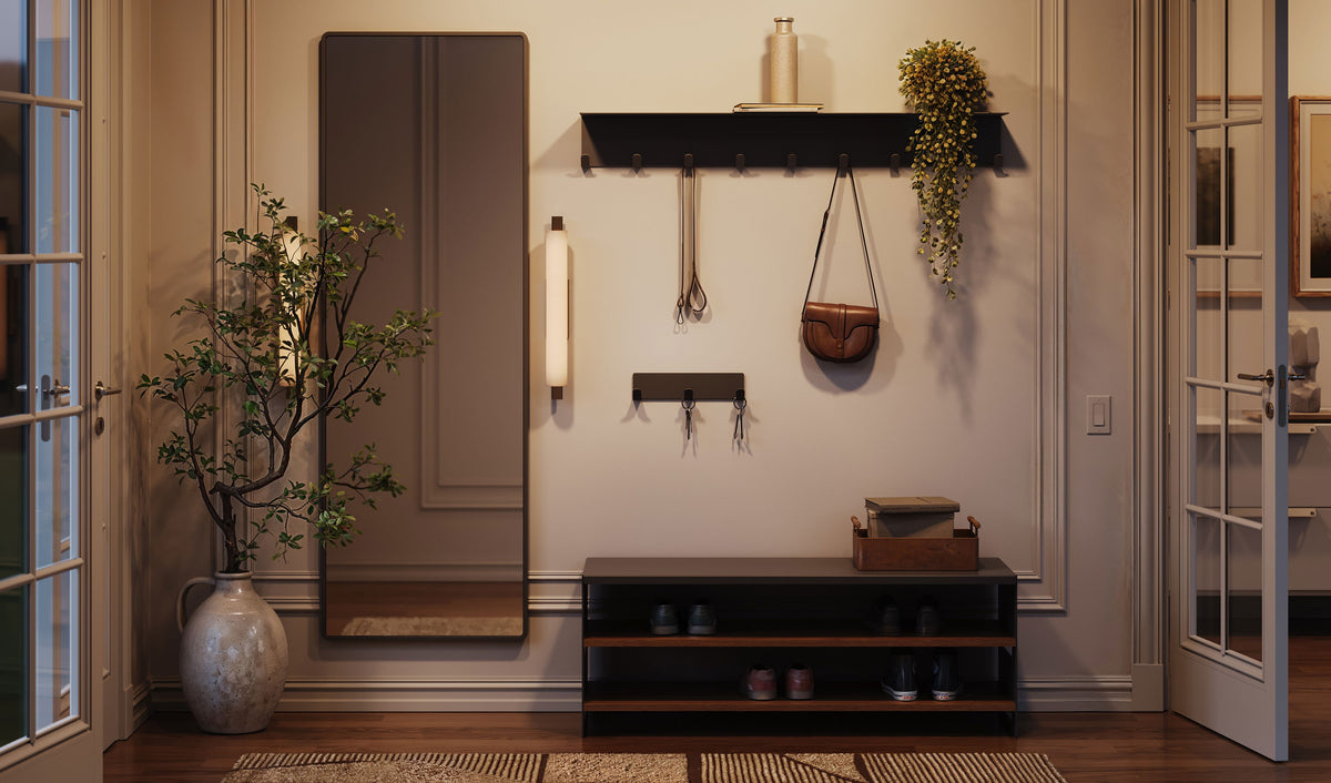 Warmly lit interior with dark wall shelves hooks framed panels a console cabinet plant and decorative objects
