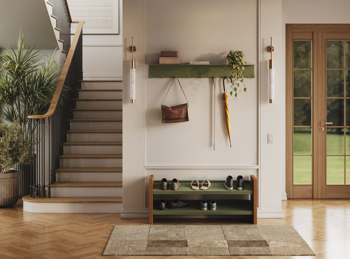 Foyer with a staircase, green wall shelf, hanging decor, shoe bench, potted plants, and glass-paneled wooden door