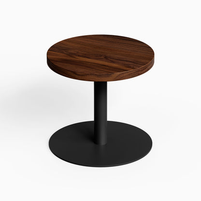 Spot On Side Table with a round dark wood top and black metal pedestal base for minimalist display and organization