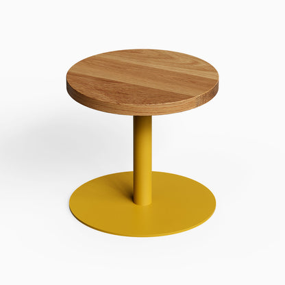 Spot On Side Table with a round wood top and golden metal pedestal base for compact functional display