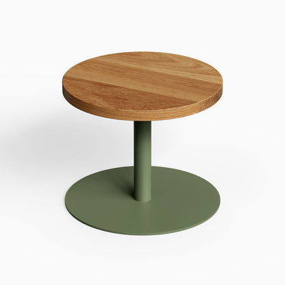 Spot On Side Table featuring a minimalist round solid hardwood top and sturdy matte green metal base designed for functional modern spaces.