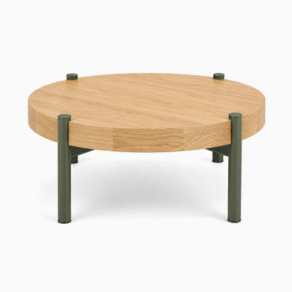 Stay Coffee Table with a round solid hardwood top and durable army green steel legs, combining minimalist design and functional style.