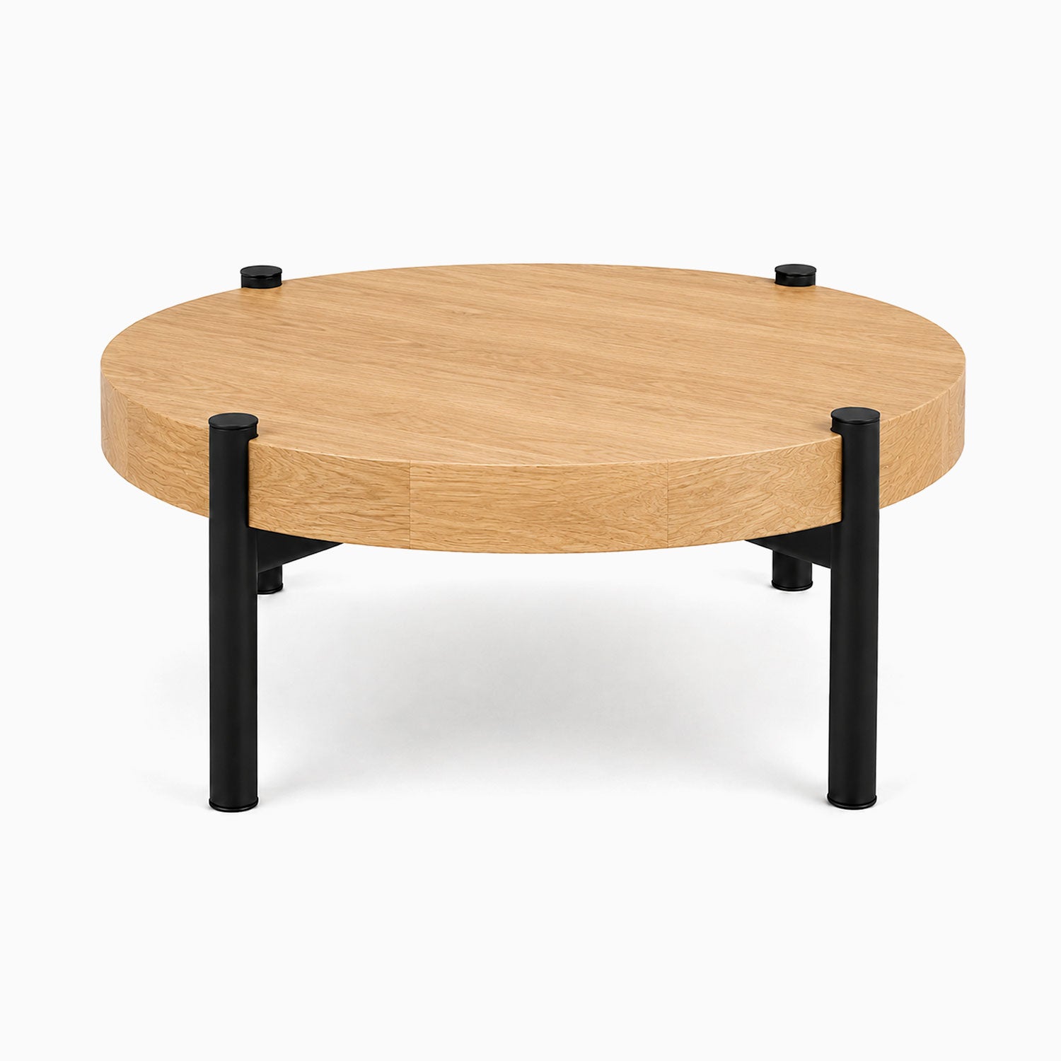 Stay Coffee Table with a round solid hardwood top and black steel legs, showcasing a minimalist design perfect for organized living spaces.